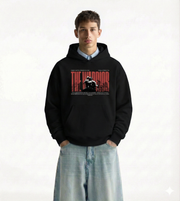 Man wearing a black hoodie with graphic design 